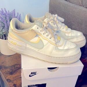 Nike Air Force ones. White with grey and pale yellow swoosh. Size 8. Used gently